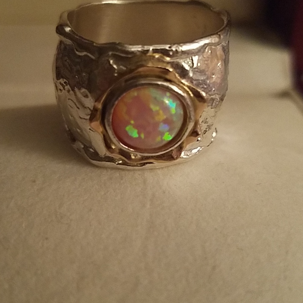 Solid silver with 14 k gold border to opal stone